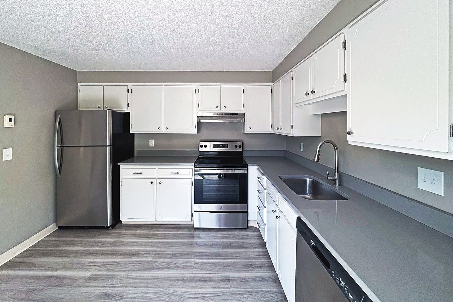 Renovated kitchen with quartz counters and stainless appliances
