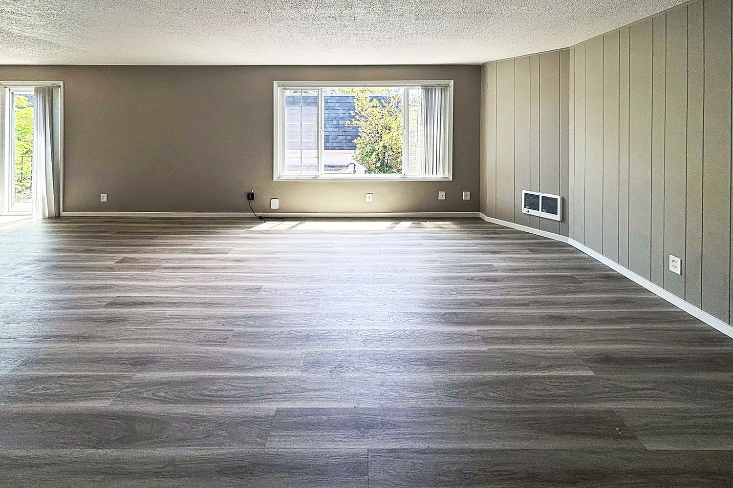 Bright renovated living room with wood-look flooring
